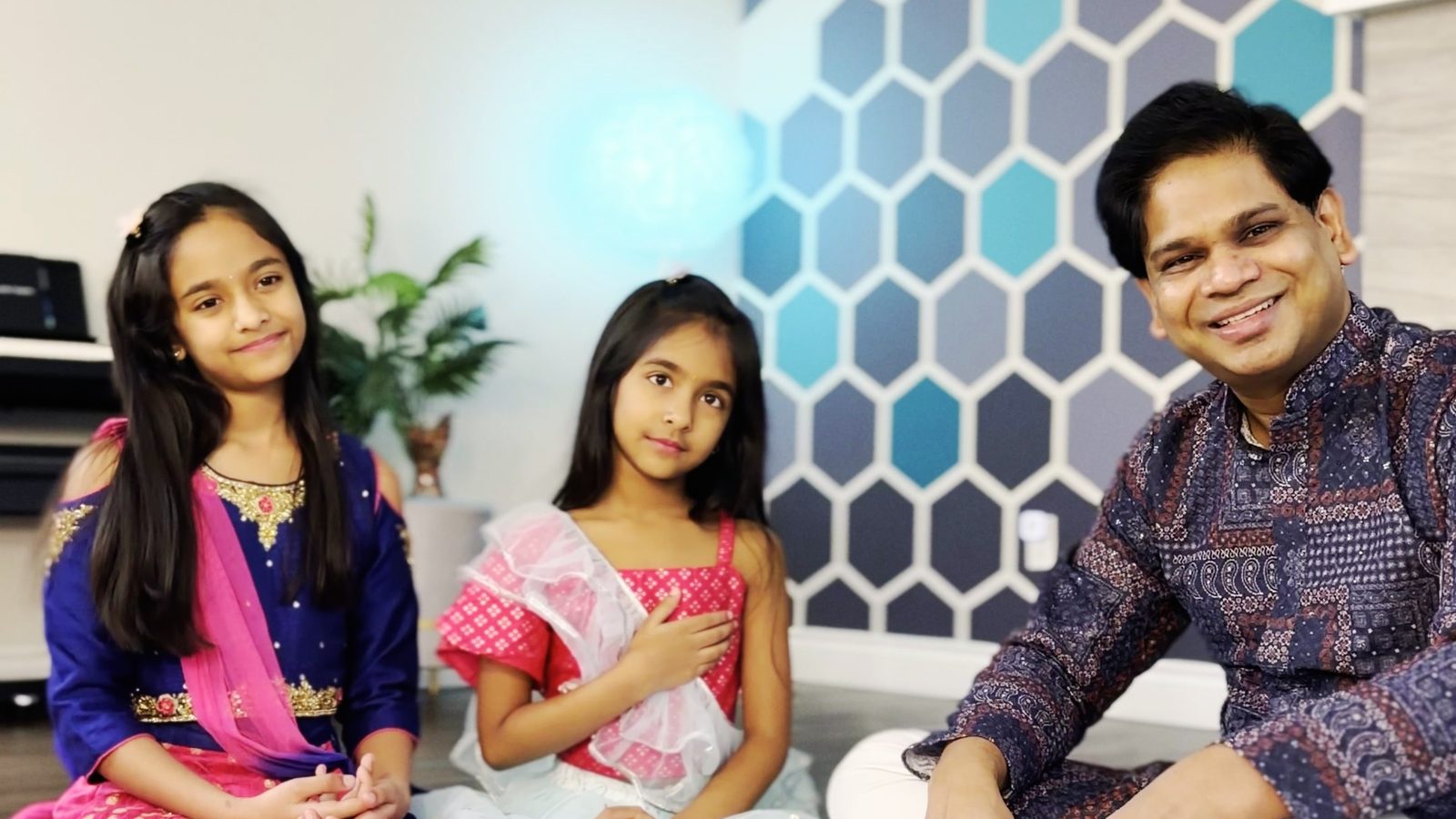 Ashish, the author of this site, at home with his two daughters, all in Indian festive dress.